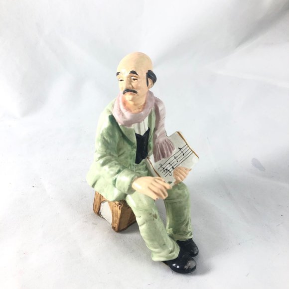 Vintage Porcelain Figurine Sitting Man in Green Suit Holding Sheet Music Hand Pa - Picture 1 of 9